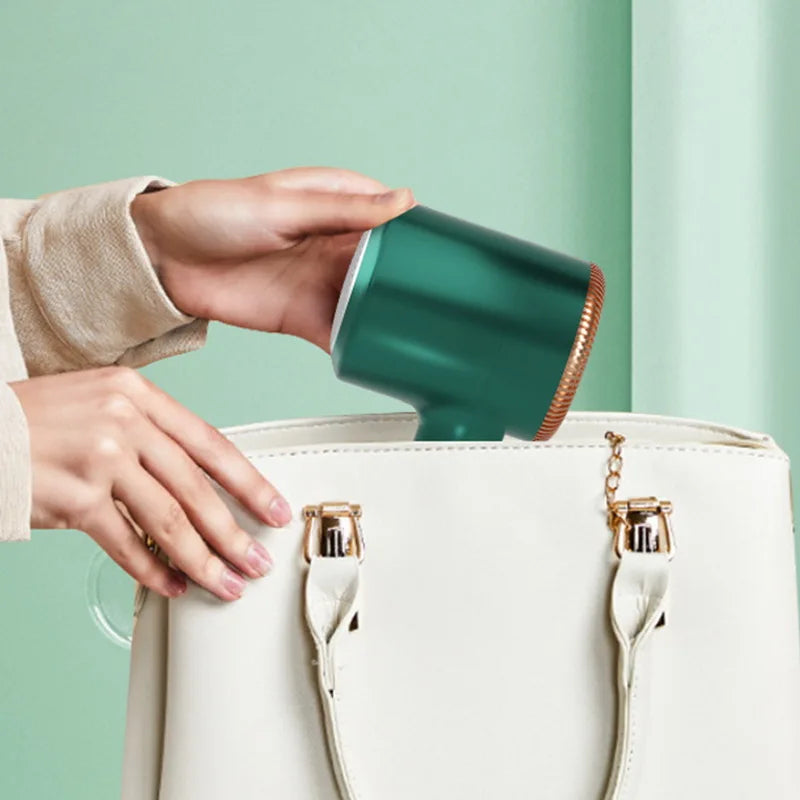 Shoppikala electric lint remover for clothes, USB rechargeable fuzz shaver and hair ball trimmer on a sweater.