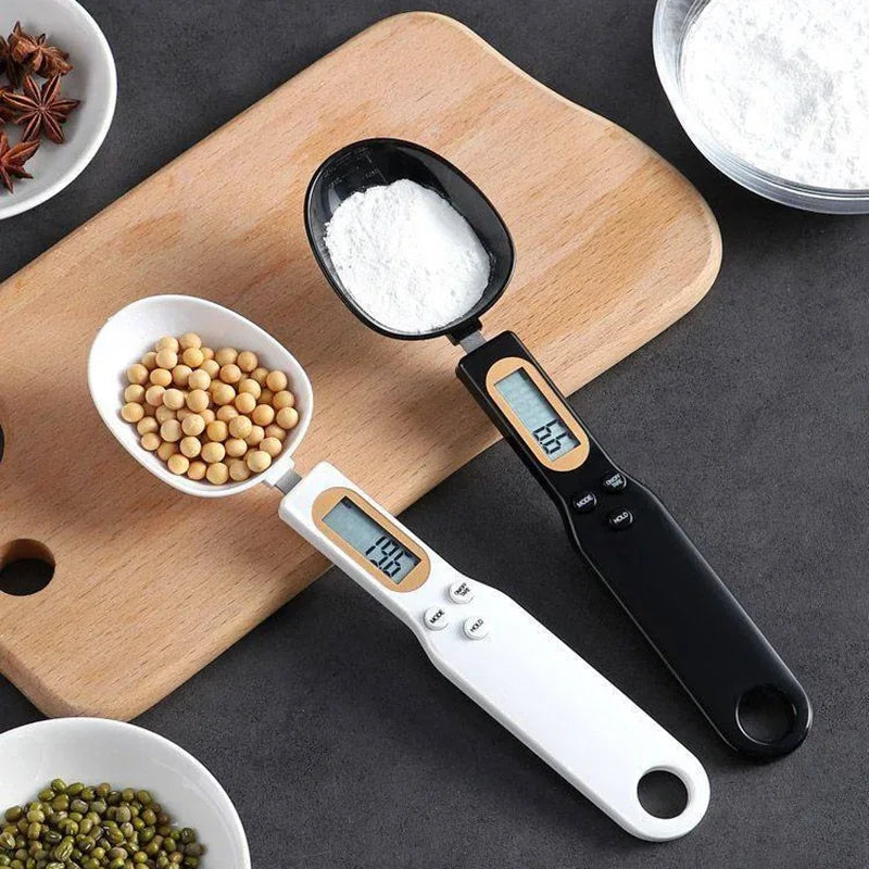 Shoppikala digital measuring spoon and kitchen scale showing 500g capacity with LCD display, used for precise food measurements.