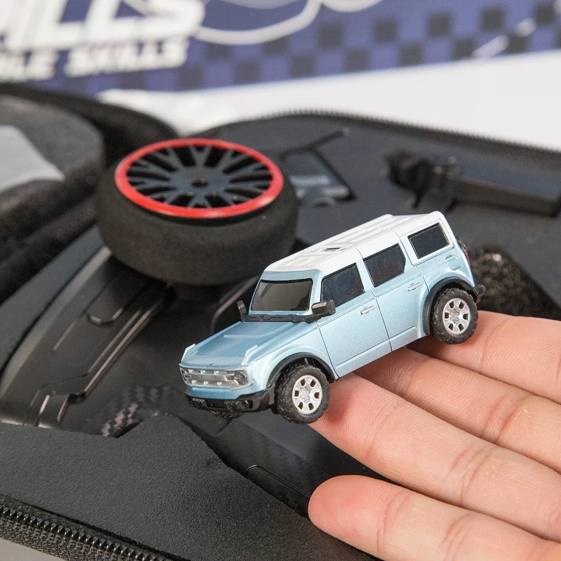 WLtoys 1/64 mini camera car with WIFI 720P FPV camera, remote control, and APP control in a racing vehicle toy for children.